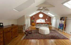 Double skylights allow plenty of natural sunlight— and moonlight—to flood in to a second story guest bedroom.