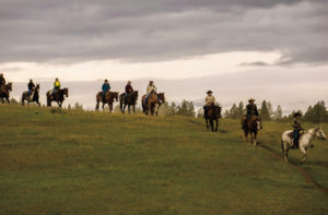 Paws Up presents guests a unique opportunity to saddle up and head out on a cattle drive alongside working ranch hands.