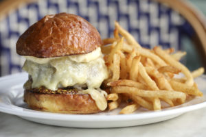 The Burger Américain, arguably one of our city’s best, is blanketed in melted Swiss and finished with grainy brown mustard.