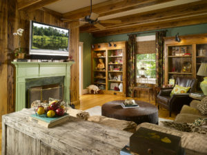 The walls in the Cruickshanks’ family room are made from Pecky Cypress. Green paint lends an air of natural earthiness and is a nod to Cheryl’s love of nature.