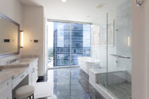 Motorized window blinds provide privacy throughout the condo, including the master bathroom.