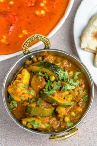 Niramish, a vegetable dish comprised of carrots, cauliflower, green peas, green beans, celery, zucchini and potato, is served with Basmati polao rice.