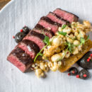 Griddled beef coulotte is served with a potato hash brown, garlic confit, huitlacoche and porcini caramel corn.